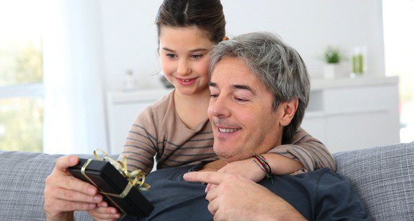 Niña dando un regalo a su padre
