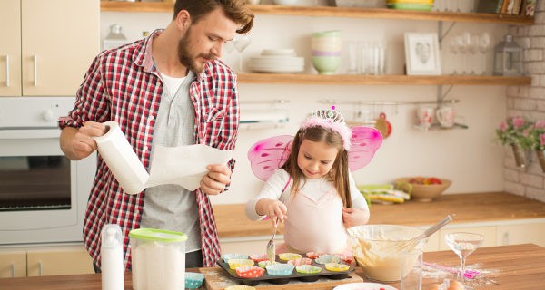 Padre e hija cocinando magdalenas