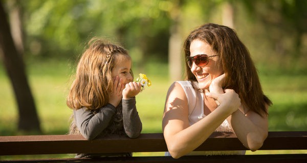Niña y madre hablando y riéndose