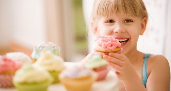 Niña comiendo cupcakes