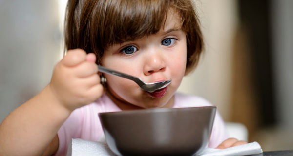 niña comiendo con la cuchara